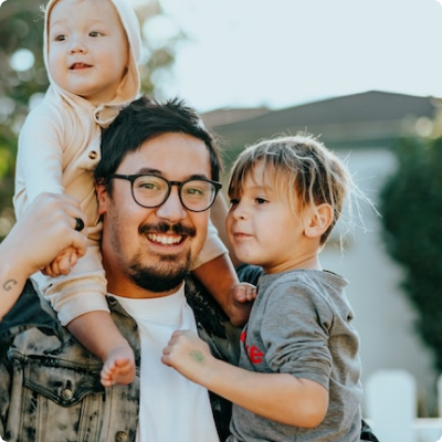 Parent with two children one on shoulders